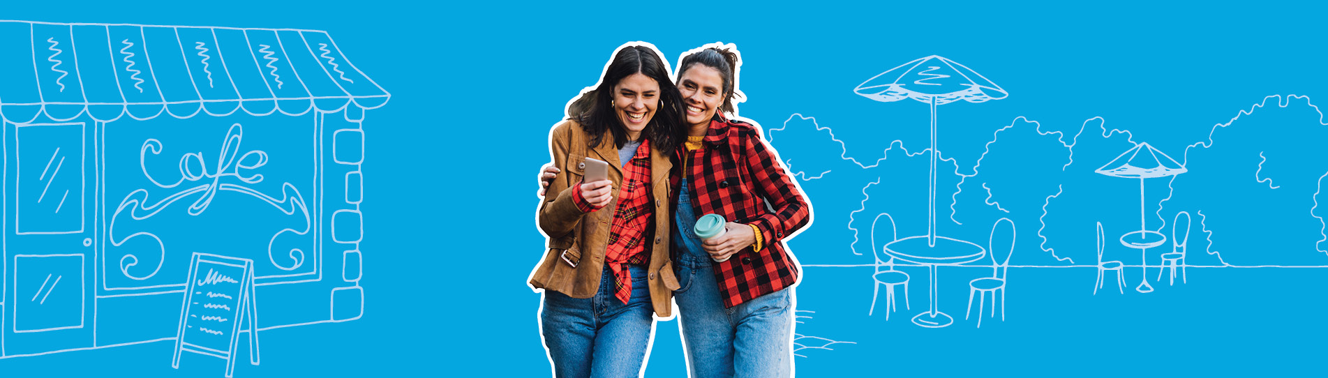 two women laughing walking arm-in-arm holding coffee cups